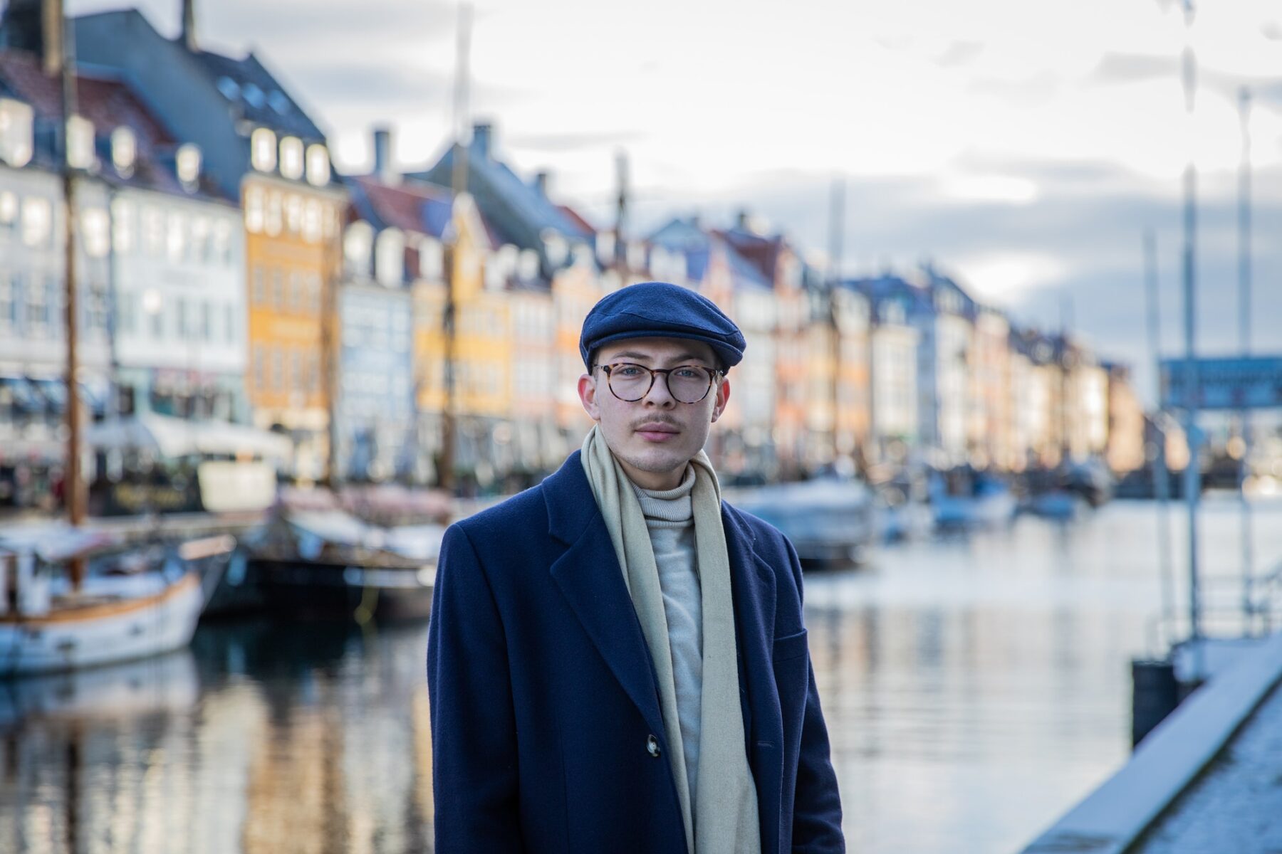 Portrait of an elegant young boy in Nyhavn, Copenhagen, the Danish capital, during a winter day