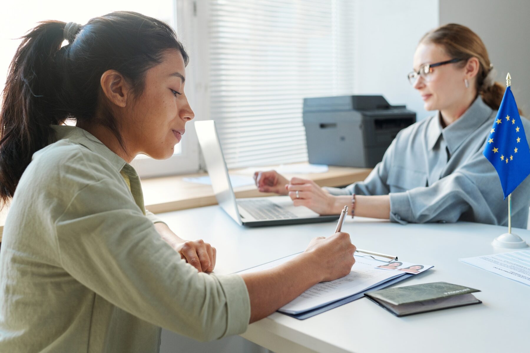 Woman Filling In Visa Application Form